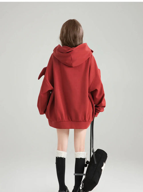 Cute oversized kawaii hoodie for girls in red worn by a model shown from the back with a large hood