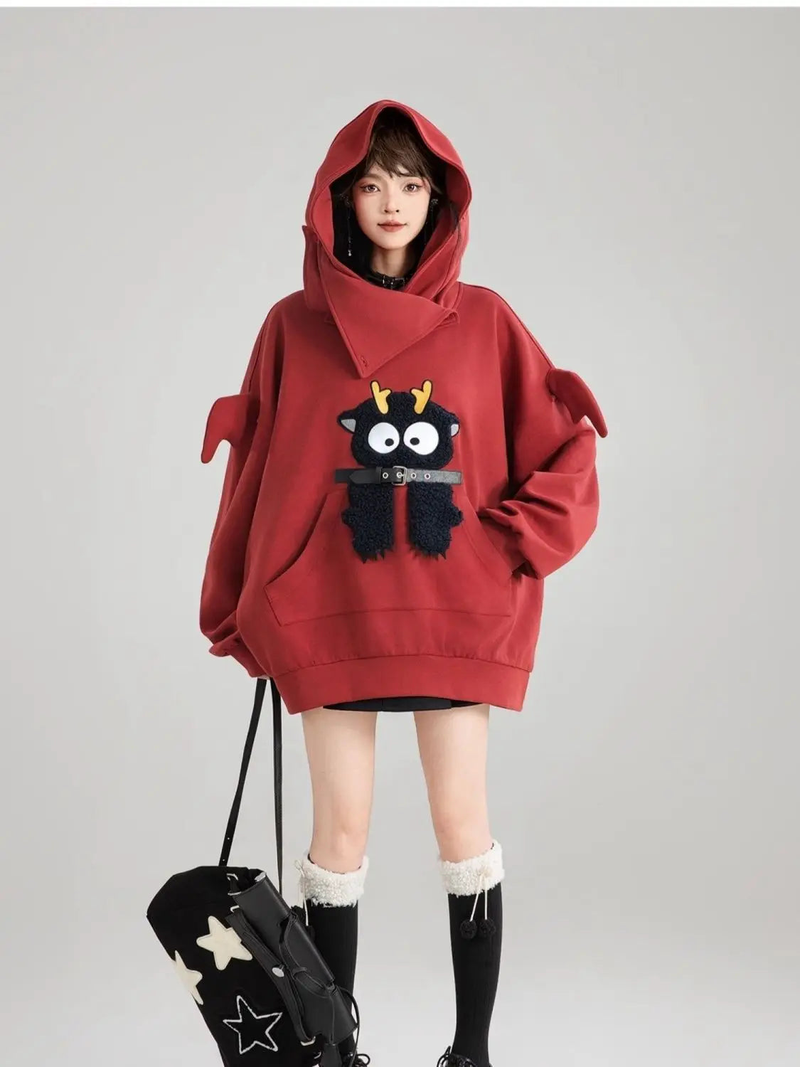 Cute oversized kawaii hoodie for girls in deep red with playful cartoon design and large hood