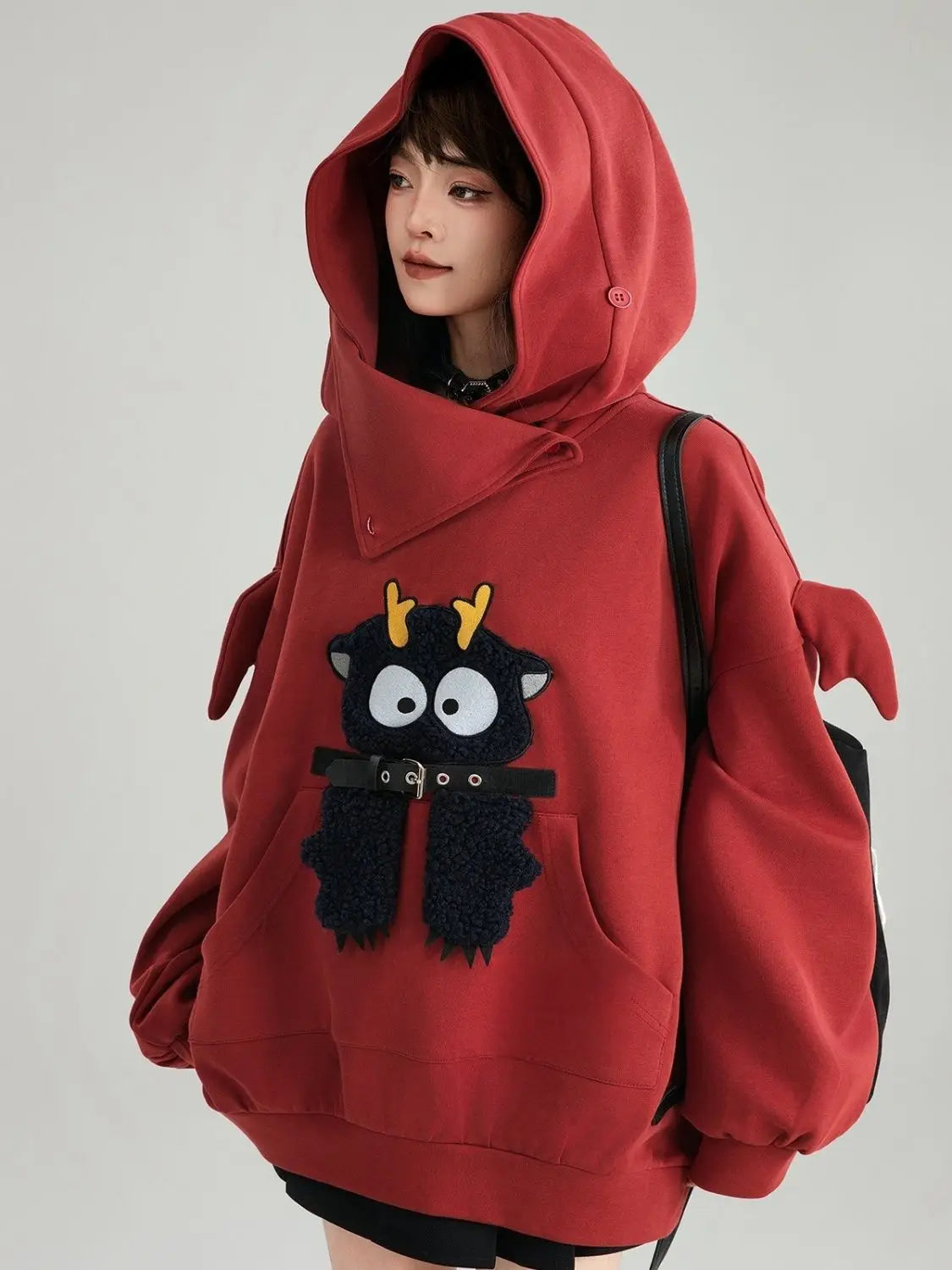 Cute oversized kawaii hoodie for girls in red with cartoon deer design and winged sleeves