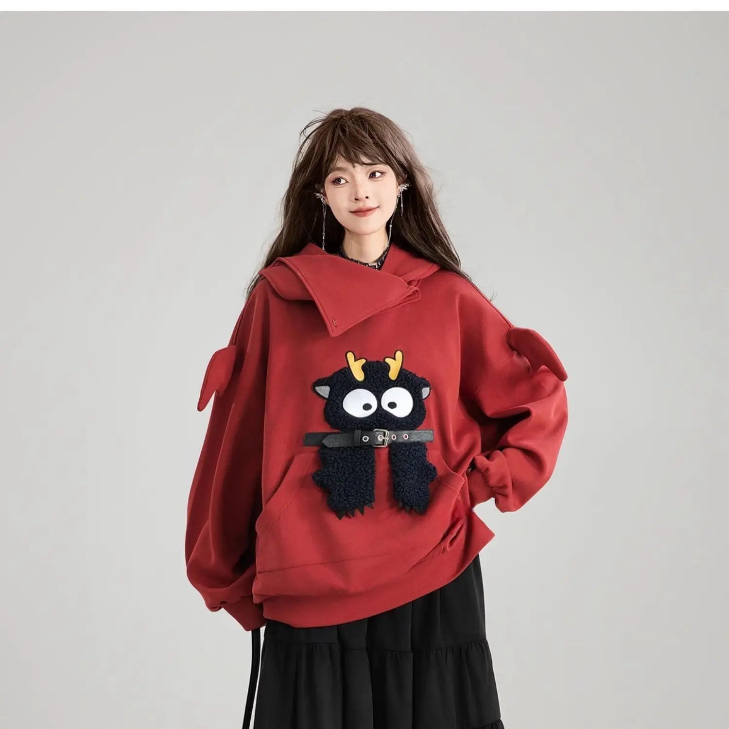 Cute oversized kawaii hoodie for girls in red with a playful cartoon animal design and large sleeves