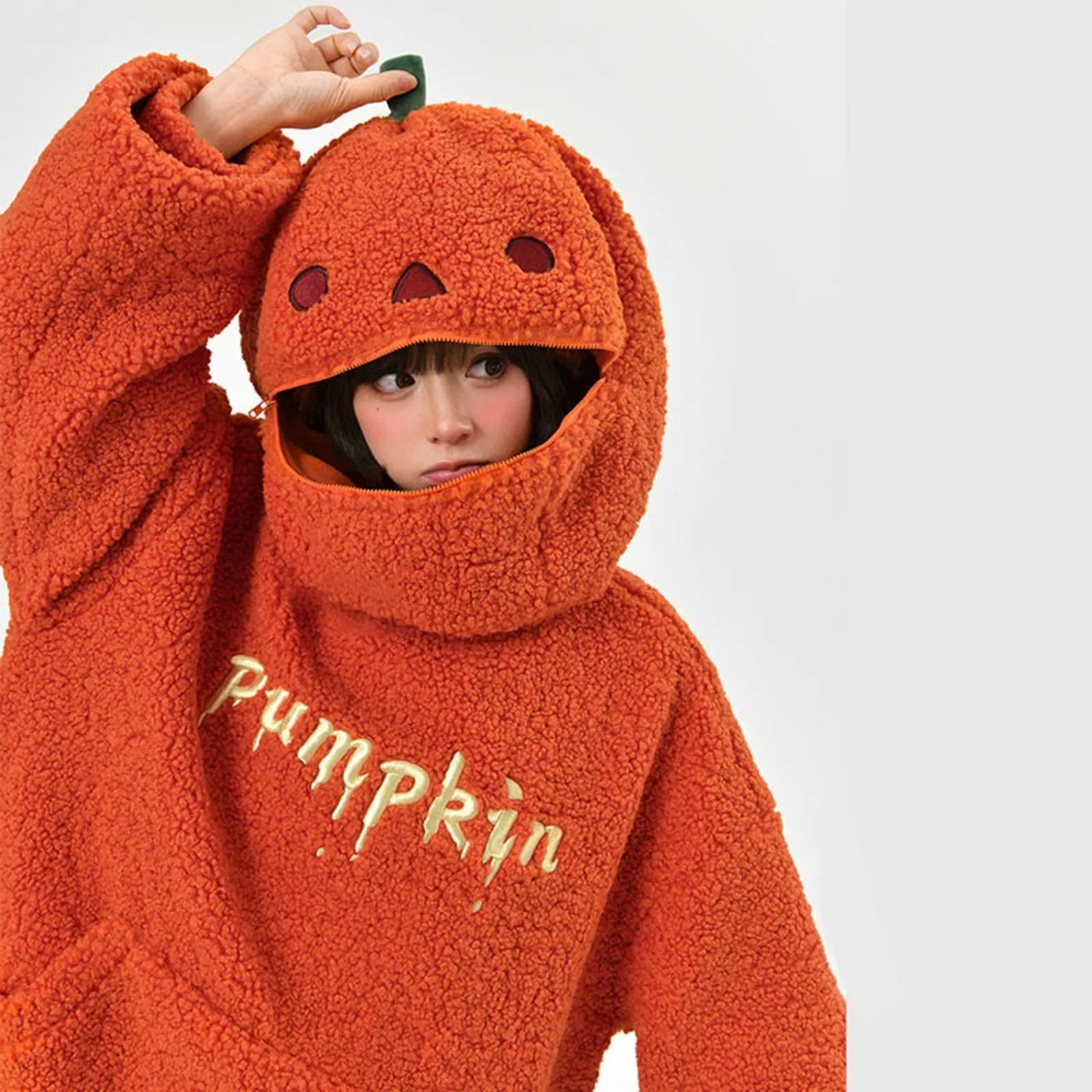 Cute pumpkin hoodie for women in orange with a pumpkin face hood and cozy fleece fabric