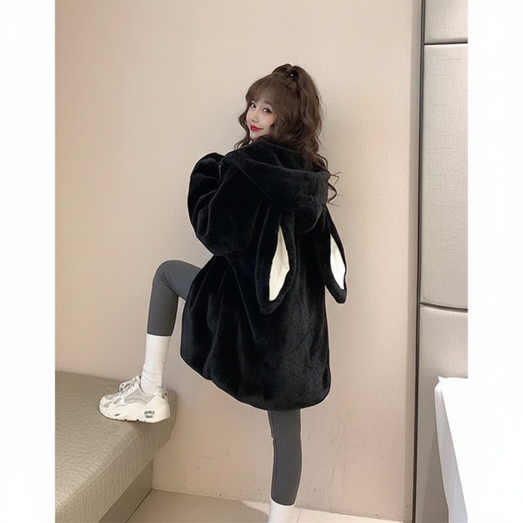 Cute rabbit hooded jacket for women in black faux fur with white inner ear details worn by a woman