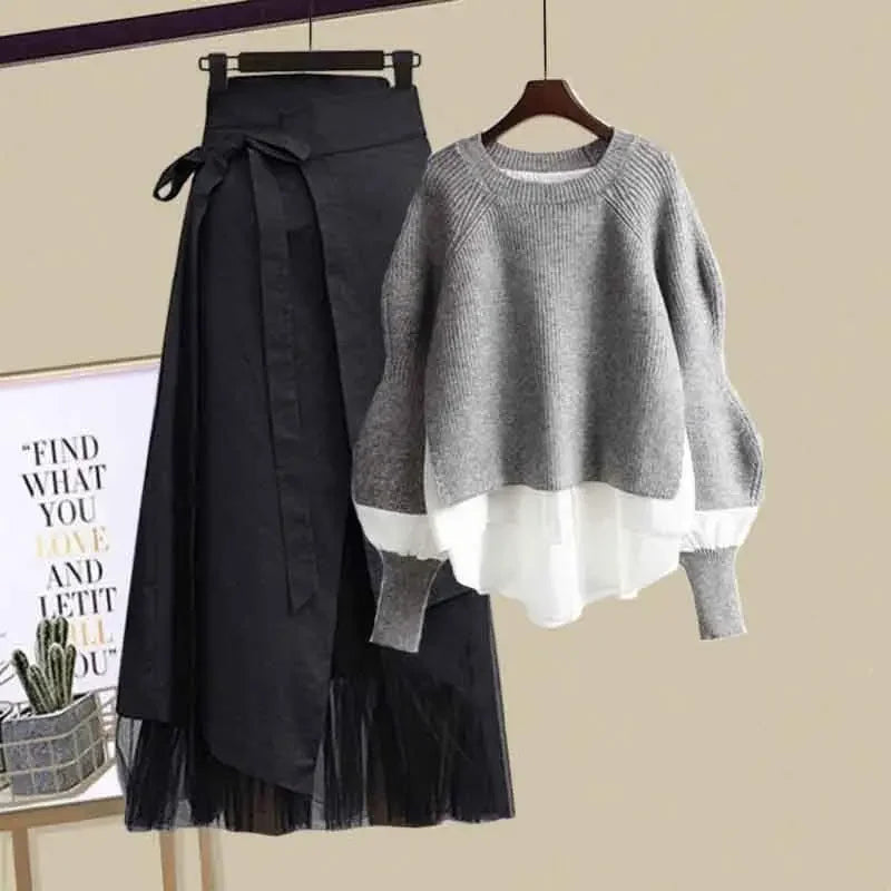 Fashionable slimming skirt set for women featuring a black skirt with bow and layered tulle paired with a grey sweater with white cuffs