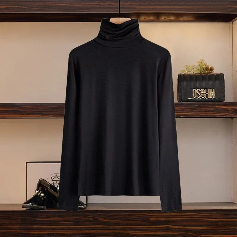 Black long sleeve turtleneck top as part of fashionable slimming skirt set for women displayed on hanger