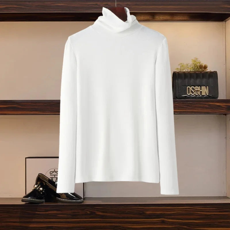 White long sleeve turtleneck top displayed on wooden shelf for fashionable slimming skirt set for women