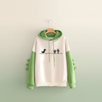Funny dinosaur sweatshirt streetwear featuring green dinosaur spikes on sleeves and pixelated dino print