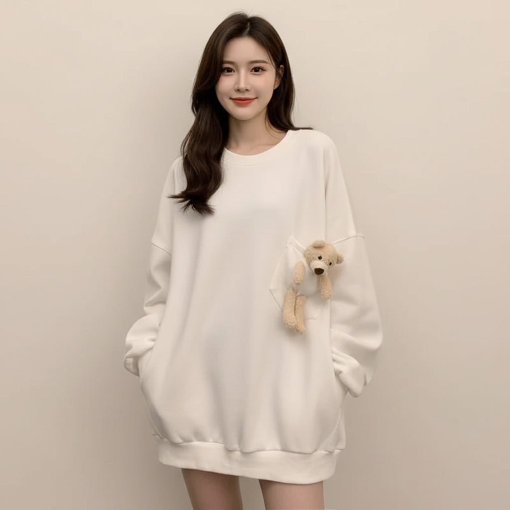 White Harajuku oversize plush cute sweatshirt with a small teddy bear in pocket worn by woman