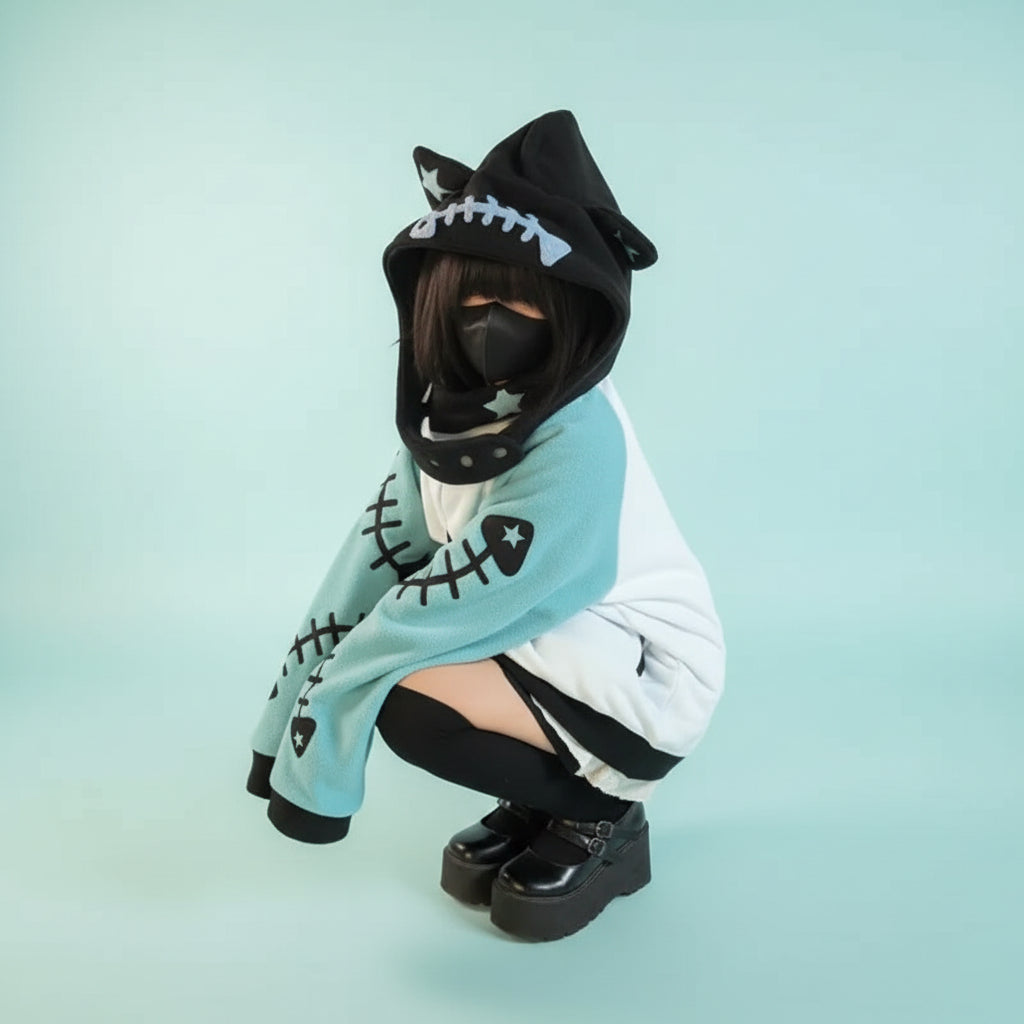 Person wearing black and teal harajuku shark grunge zip up sweatshirt with hood and face mask outdoor