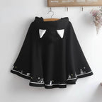 Black Harajuku style cape for women with white cat ear details and cute animal designs on the hem