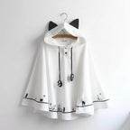 White Harajuku style cape for women with black cat ear hood and cat paw details on sleeves