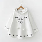White Harajuku style cape for women with black paw prints and hood from Vusy Kawai Shop