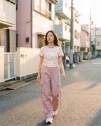 Model wearing the puppy tee and pink cargo pants set on the street