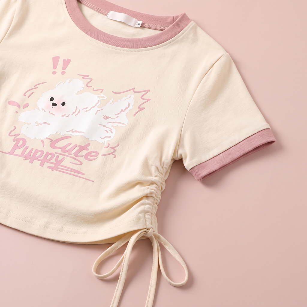 Close-up of the puppy print, pink ringer collar and side drawstring detail