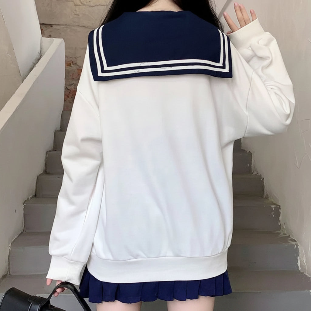 Back view of a white Japanese preppy style casual sweatshirt with navy sailor collar and striped detail