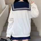 Back view of a white Japanese preppy style casual sweatshirt with navy sailor collar and striped detail