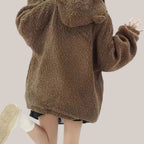 Back view of a woman wearing a brown japanese style lamb wool coat with a hood and bear ears