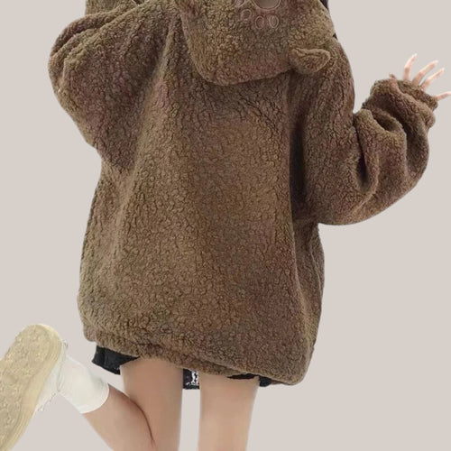 Back view of a woman wearing a brown japanese style lamb wool coat with a hood and bear ears