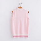 Back view of pink Japanese style rabbit knit vest with white and pink striped hem hanging on wooden hanger