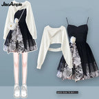 Women's floral sling dress set featuring black floral dress with white flower detail and white cropped long sleeve top