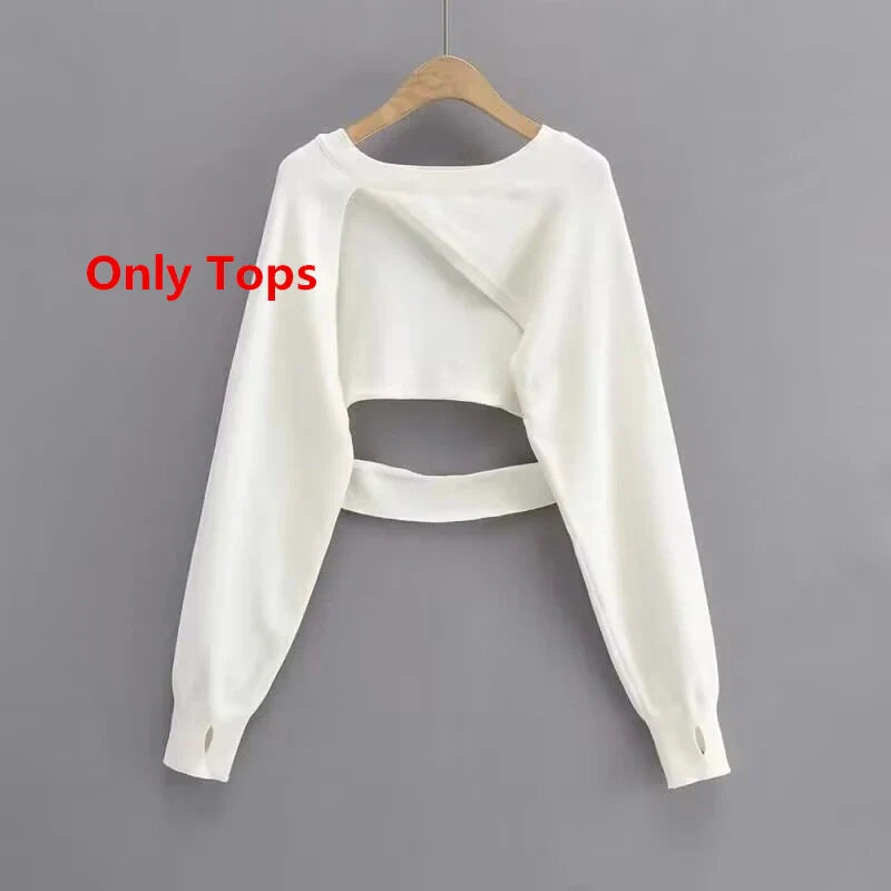 White cropped long sleeve top hanging on wooden hanger only for women's floral sling dress set