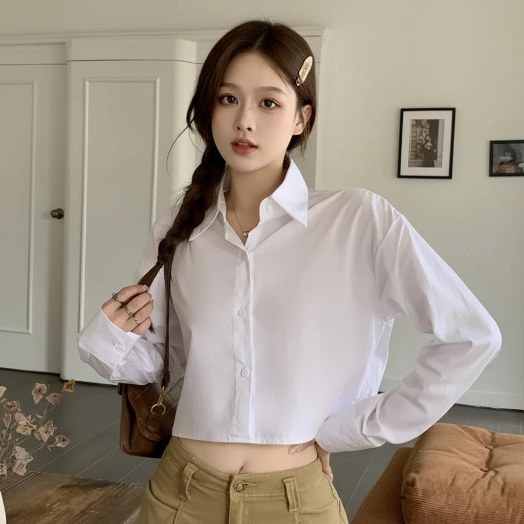 Young woman wearing Korean striped shirt and sweater set white cropped shirt with beige pants indoors
