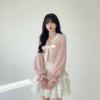 Young woman wearing a pink bowknot two piece skirt set with long puff sleeves and lace details