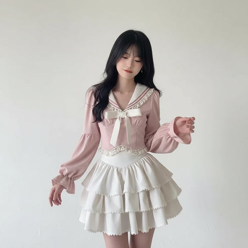 Woman wearing a pink bowknot two piece skirt set with long puff sleeves and layered white skirt indoors