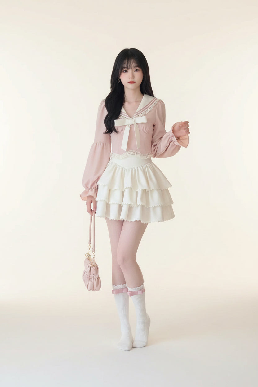 Woman wearing pink bowknot two piece skirt set with long puff sleeves and tiered white skirt