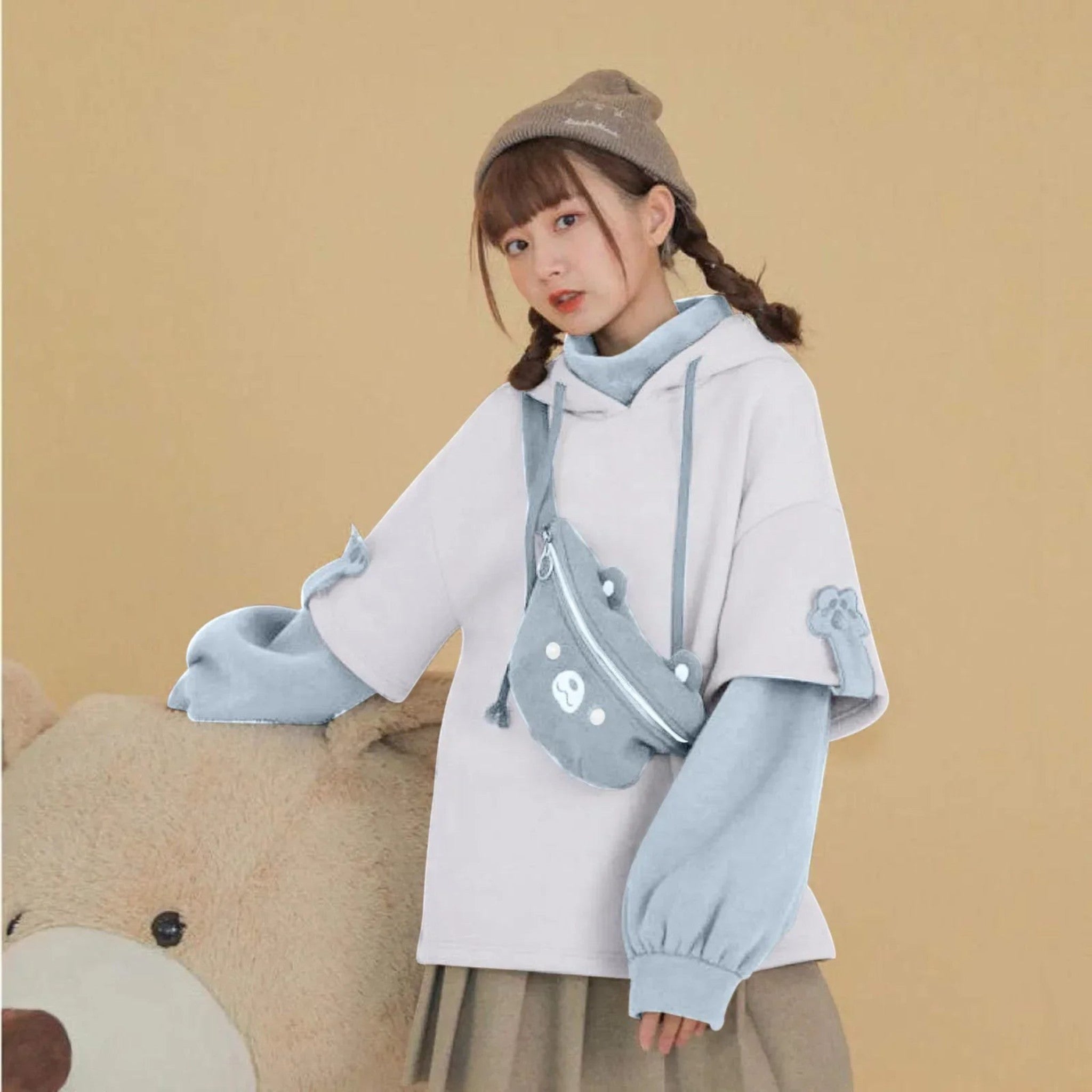 Woman wearing kawaii bear anime Crewneck Long Sleeve hoodie in white and blue with a matching bear-themed crossbody bag