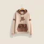 Kawaii bear japanese hoodie for women in beige and brown with bear graphic and pom pom drawstrings