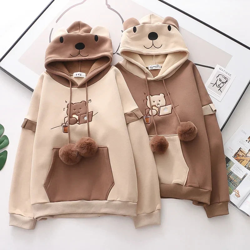 Two kawaii bear japanese hoodie for women in beige and brown with bear face hoods and pom pom drawstrings