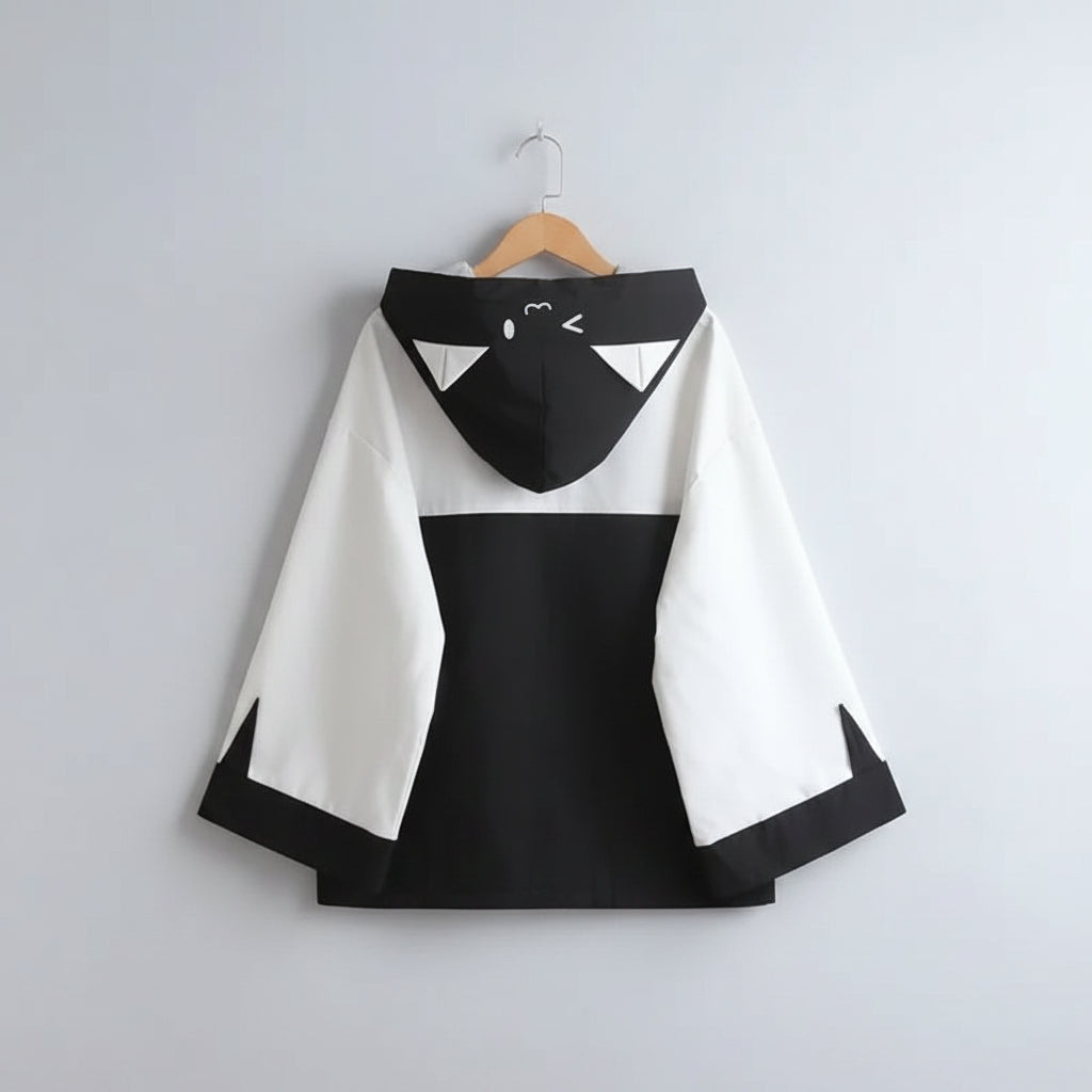 Back view of kawaii cat ear hooded jacket for women in black and white with cute face design on the hood
