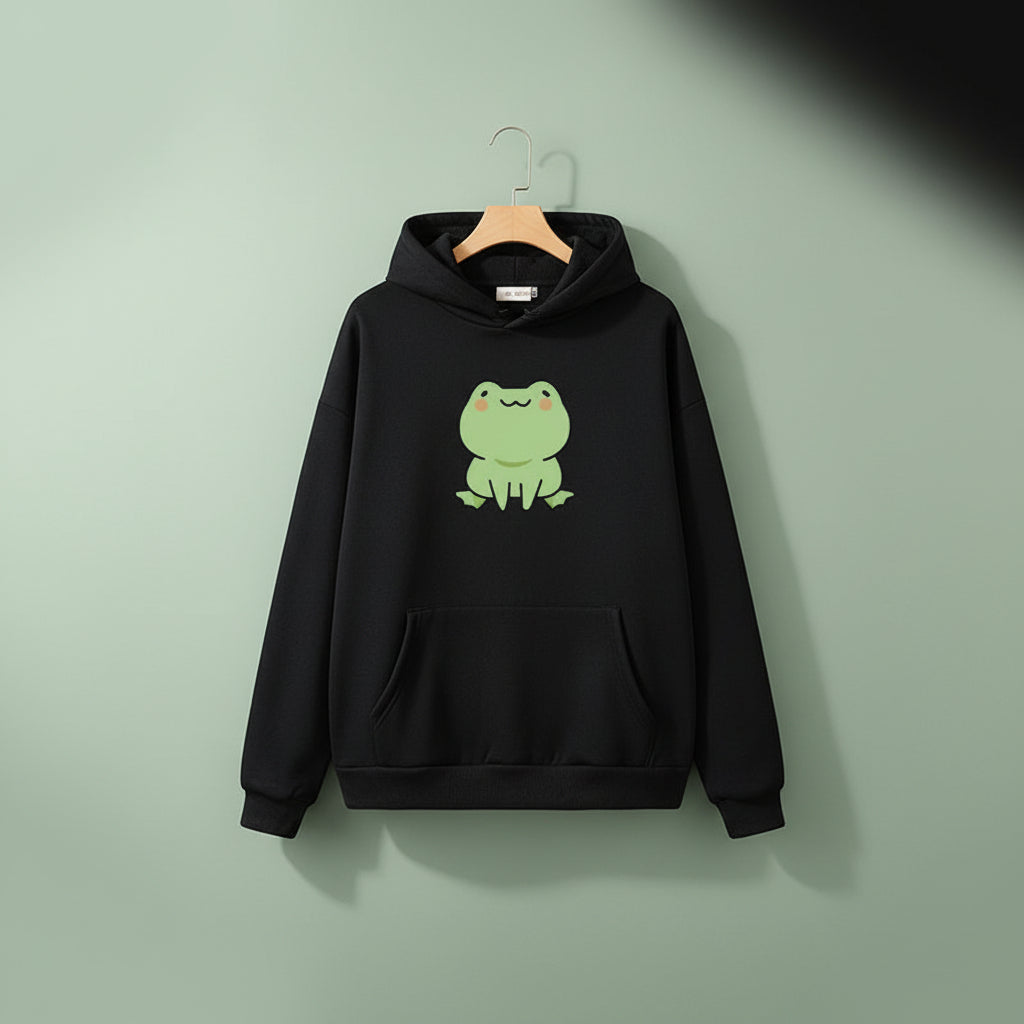 Black kawaii Japanese frog hoodie with pockets featuring a cute green frog graphic on front