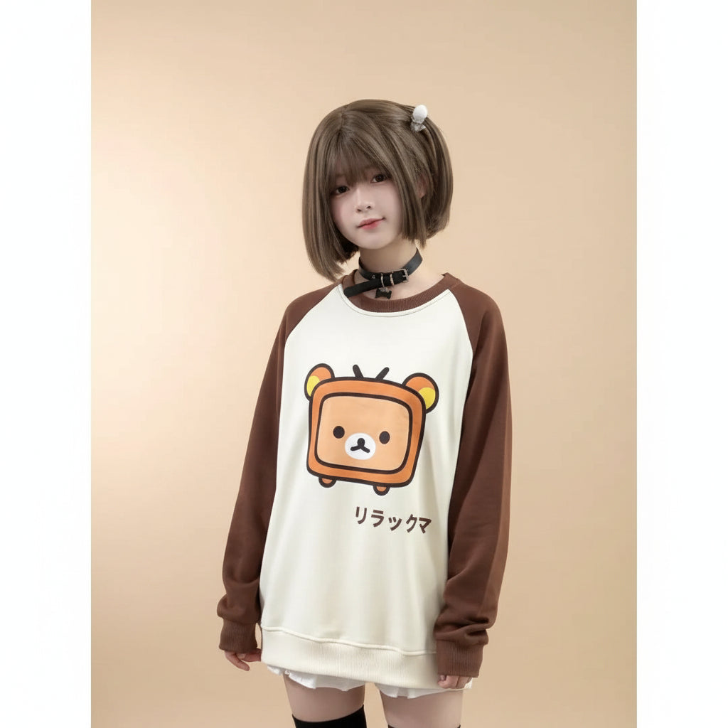 Japanese kawaii pullover top with brown sleeves and a cute bear graphic worn by a model inside