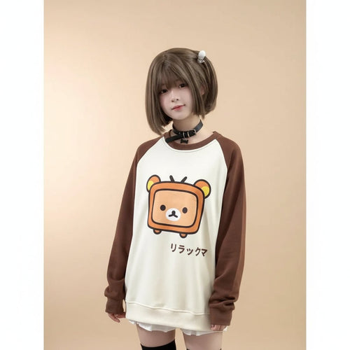 Japanese kawaii pullover top with brown sleeves and a cute bear graphic worn by a model inside