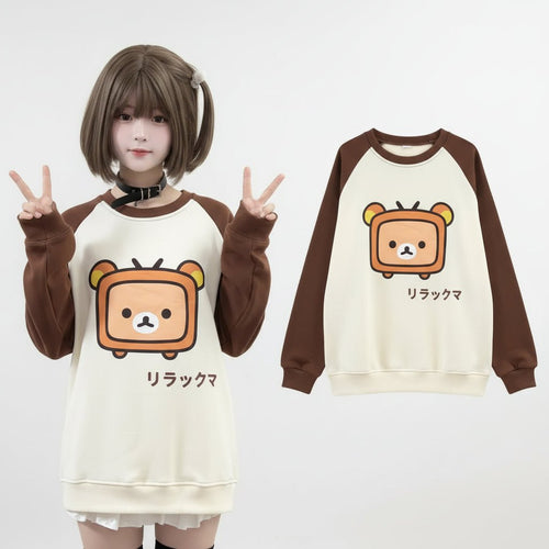 Japanese kawaii pullover top with brown sleeves and cute bear graphic on front worn by model
