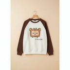 Japanese kawaii pullover top with brown sleeves and a cute bear TV character on front