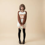 Japanese kawaii pullover top with brown sleeves and cute bear toast graphic worn with black stockings