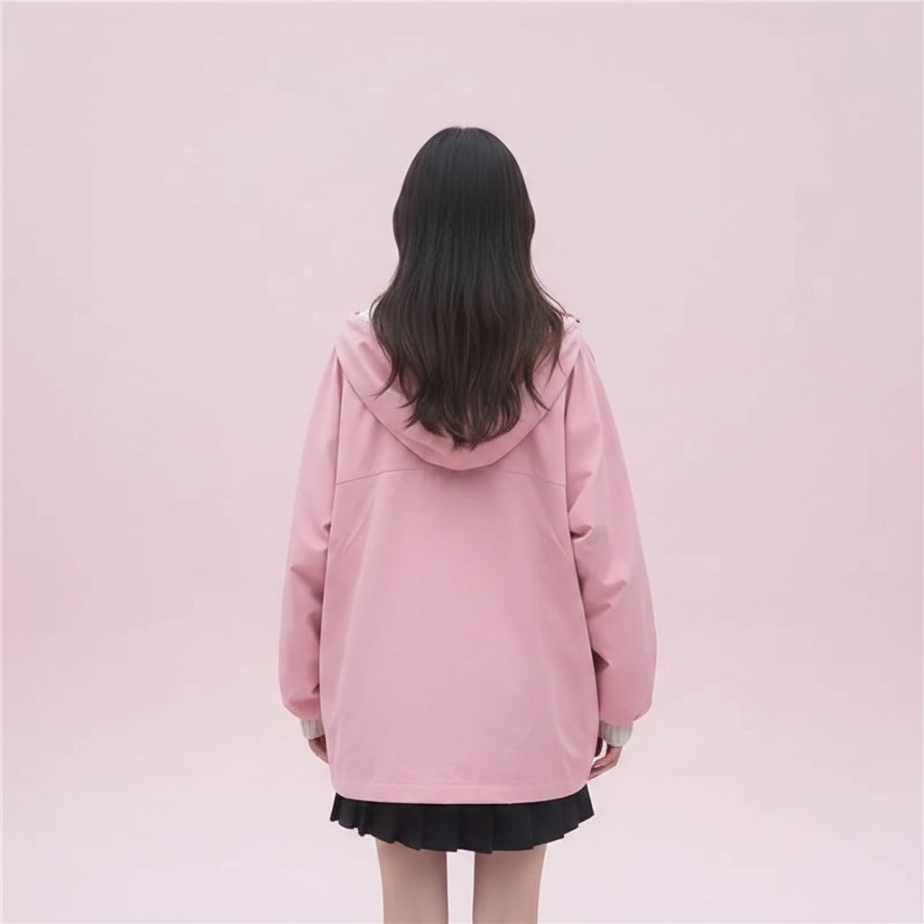 Woman wearing pink kawaii japanese style spring outerwear with hood and oversized fit walking outdoors