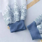 Close-up of cuffs on kawaii loose long sleeve spring hoodie with blue ribbed trim and wave pattern