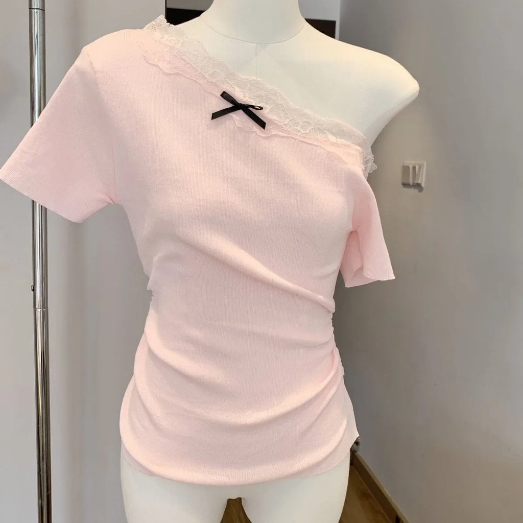 Kawaii pink bowknot top and skirt set featuring an off-shoulder pink top with lace trim and black bow