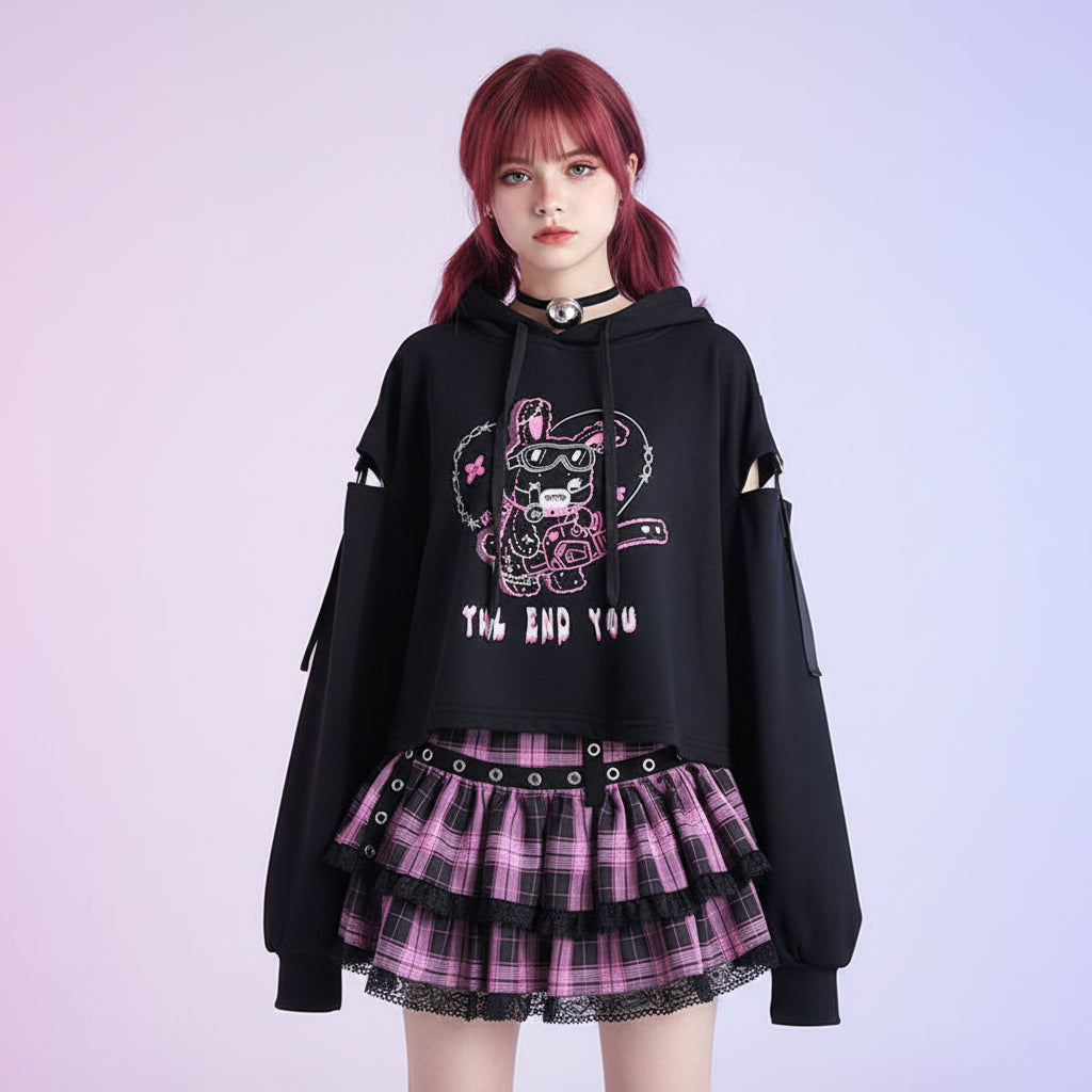 Kawaii preppy patchwork crop hoodie in black with pink graphic and cutout sleeves styled with pink plaid layered skirt
