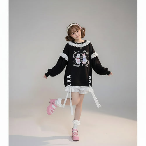 Woman wearing kawaii print casual O-neck sweatshirt with bunny design and lace details in a cozy room