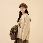 Woman wearing kawaii style bear sweater for women in beige with oversized fit and cozy knit design