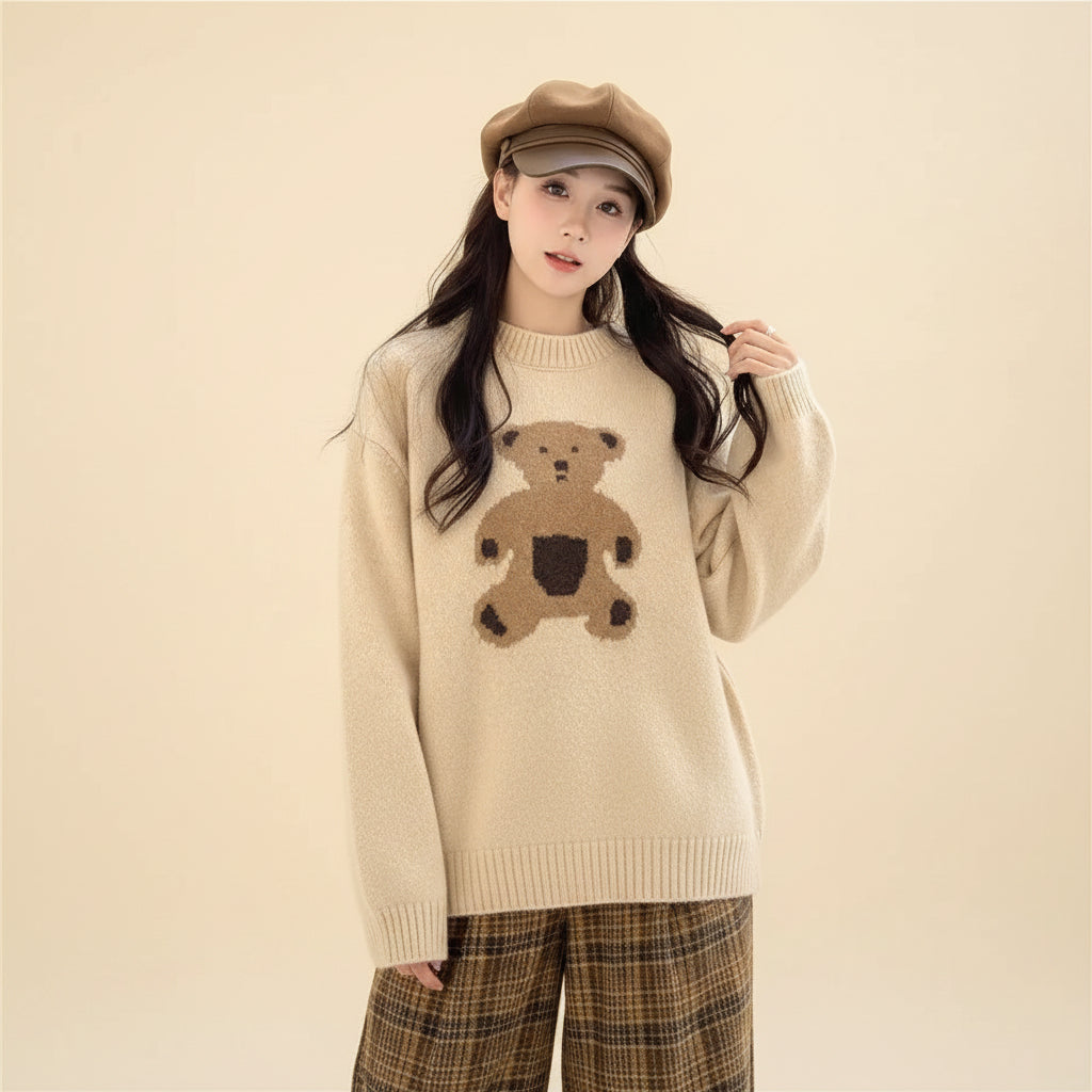 Woman wearing a beige kawaii style bear sweater for women with a brown bear design sitting outdoors