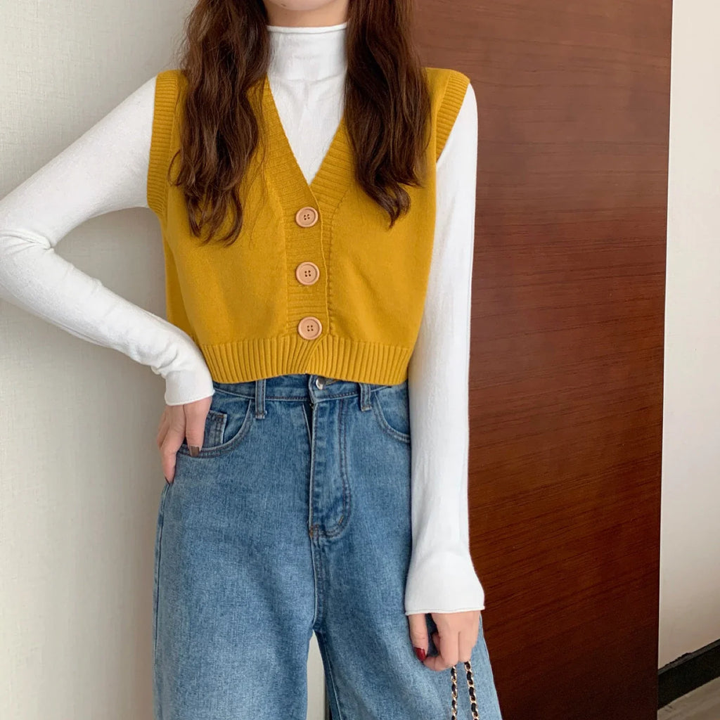 Korean fashion crop knit top in yellow with buttons, layered over a white long sleeve shirt