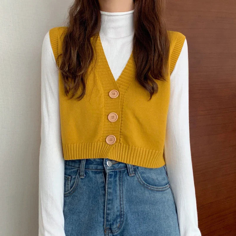 Korean fashion crop knit top in mustard yellow with three buttons, layered over a white long-sleeve shirt