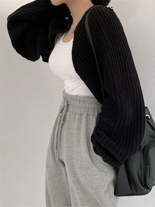 Model wearing a Korean knitted short cardigan in black, paired with a white top and gray sweatpants