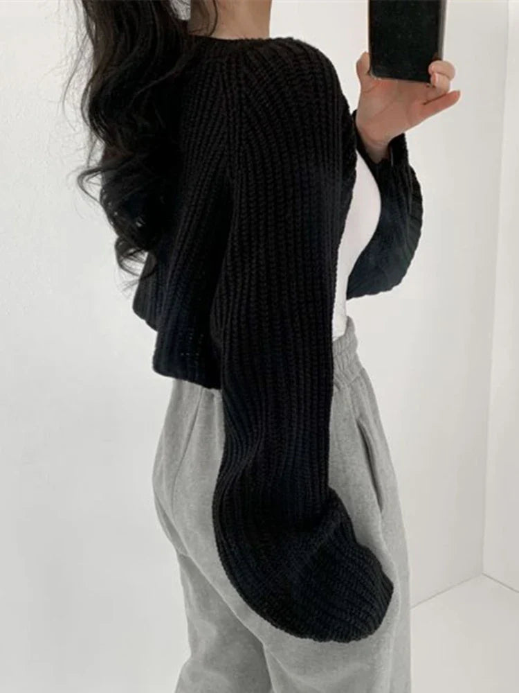 Korean knitted short cardigan in black, featuring wide sleeves and a cropped design, perfect for layering