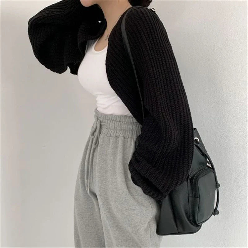 Korean knitted short cardigan in black worn over a white tank top and paired with gray sweatpants